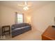Bedroom with a ceiling fan, couch, carpeted floor, end table, and closet at 6408 Old Mill Dr, Indianapolis, IN 46221