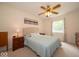 Bedroom with neutral carpet, a ceiling fan, and a window with a view of the green trees outside at 6408 Old Mill Dr, Indianapolis, IN 46221