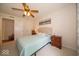 Bedroom with a ceiling fan, queen bed, carpeted floor, and closet at 6408 Old Mill Dr, Indianapolis, IN 46221