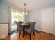 Cozy dining area featuring a round table with seating for four and sliding glass doors to the screened in porch at 6408 Old Mill Dr, Indianapolis, IN 46221