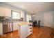 Bright kitchen featuring white cabinets, stainless steel appliances, tile backsplash, and view of dining area at 6408 Old Mill Dr, Indianapolis, IN 46221