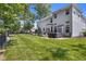Expansive backyard featuring a deck with a hot tub and lush lawn for outdoor enjoyment at 6524 Turning Leaf Ln, Indianapolis, IN 46236