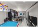 Wet bar with stone accent, modern barstools, and a view of the game room at 6524 Turning Leaf Ln, Indianapolis, IN 46236