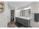Bathroom featuring double vanity, decorative mirrors, stone floors, and great natural light at 6524 Turning Leaf Ln, Indianapolis, IN 46236
