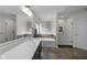 Bright bathroom featuring double vanity, soaking tub, and glass shower with decorative tile and stone floor at 6524 Turning Leaf Ln, Indianapolis, IN 46236