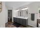 Bathroom featuring double vanity, decorative mirrors, stone floors, and great natural light at 6524 Turning Leaf Ln, Indianapolis, IN 46236