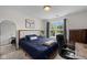 Comfortable bedroom with a large bed, wood desk, and great natural light at 6524 Turning Leaf Ln, Indianapolis, IN 46236