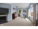 Bright bedroom featuring a fireplace, large window, and door to balcony at 6524 Turning Leaf Ln, Indianapolis, IN 46236