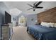 Cozy bedroom features modern ceiling fan, wood accent wall and a fireplace at 6524 Turning Leaf Ln, Indianapolis, IN 46236