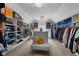 Spacious walk-in closet with custom shelving, central island, and a plush seating area at 6524 Turning Leaf Ln, Indianapolis, IN 46236