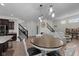 Open-concept dining area features modern lighting, stairs, and easy access to the living spaces at 6524 Turning Leaf Ln, Indianapolis, IN 46236