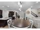 Open-concept dining area features modern lighting, stairs, and easy access to the living spaces at 6524 Turning Leaf Ln, Indianapolis, IN 46236