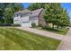 View of the home's side and back exterior and driveway, showcasing the attached garage at 6524 Turning Leaf Ln, Indianapolis, IN 46236