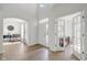 Bright foyer with hardwood floors, white walls, front door, and french door entry at 6524 Turning Leaf Ln, Indianapolis, IN 46236