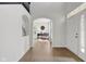 Bright foyer with hardwood floors, white walls, archway, and entry to living room at 6524 Turning Leaf Ln, Indianapolis, IN 46236