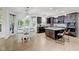 Bright kitchen with hardwood floors, an island, pendant lights and dark wood cabinets at 6524 Turning Leaf Ln, Indianapolis, IN 46236