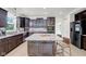 Spacious kitchen boasts dark cabinets, granite countertops, and stainless steel appliances at 6524 Turning Leaf Ln, Indianapolis, IN 46236