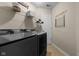 Laundry room has black washer and dryer set, overhead shelving, and decor at 6524 Turning Leaf Ln, Indianapolis, IN 46236