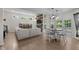 Open-concept living room with hardwood floors, modern decor, and an eat-in kitchen at 6524 Turning Leaf Ln, Indianapolis, IN 46236