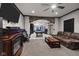 Spacious living room featuring a fireplace and arched brick entryway to game room at 6524 Turning Leaf Ln, Indianapolis, IN 46236