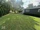 A view of the grassy backyard with manicured lawn and trimmed shrubs at , Indianapolis, IN 46227