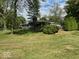 A view of the grassy backyard surrounded by mature trees and shrubs at , Indianapolis, IN 46227