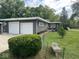 Well-maintained single-story home with a lush front lawn, mature trees, and a two-car garage at , Indianapolis, IN 46227
