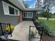 Inviting front porch with a vibrant orange door, decorative flowers, and well-kept landscaping at , Indianapolis, IN 46227