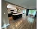 Open kitchen featuring stainless steel appliances, large island with seating, and wood flooring at , Indianapolis, IN 46227