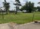 Expansive backyard featuring mature trees, a shed, and a basketball court at 705 Orchard Ln, Greenwood, IN 46142