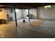 Spacious basement featuring concrete floors, exposed ceiling, and natural light from two windows at 705 Orchard Ln, Greenwood, IN 46142
