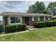 Charming brick ranch-style home with well-manicured lawn and trimmed shrubbery at 705 Orchard Ln, Greenwood, IN 46142