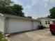 Spacious two-car garage with white doors and a concrete driveway at 705 Orchard Ln, Greenwood, IN 46142