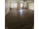 Open living room featuring vinyl flooring, neutral walls, and a ceiling fan at 705 Orchard Ln, Greenwood, IN 46142