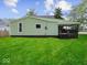 The backyard has a lush green lawn and a covered porch, offering a relaxing outdoor space at 720 Blanchard St, Shelbyville, IN 46176