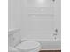 Clean and white bathroom featuring modern fixtures, subway tile, tub, and neutral flooring at 720 Blanchard St, Shelbyville, IN 46176