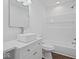 A modern bathroom with a square sink, wood floor, shower with a tub, and white walls at 720 Blanchard St, Shelbyville, IN 46176
