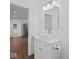 Bright bathroom with a square sink, a large mirror, white fixtures, and wood floor at 720 Blanchard St, Shelbyville, IN 46176