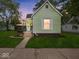 Charming single-Gathering home with light green siding, a covered porch, and a well-manicured front lawn at 720 Blanchard St, Shelbyville, IN 46176