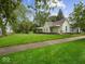 Charming exterior featuring a sprawling green lawn, a quaint porch, and well-maintained landscaping at 720 Blanchard St, Shelbyville, IN 46176