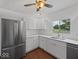 Stylish kitchen showcasing stainless steel appliances, white cabinets, and a view of the backyard at 720 Blanchard St, Shelbyville, IN 46176