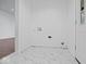 Tiled laundry room with white walls, hookups, and a nearby door at 720 Blanchard St, Shelbyville, IN 46176