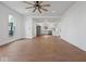 Spacious living area featuring hardwood flooring, white walls, and an open layout to the kitchen at 720 Blanchard St, Shelbyville, IN 46176