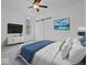 Comfortable main bedroom featuring a barn door, ceiling fan, TV, and relaxing decor at 720 Blanchard St, Shelbyville, IN 46176