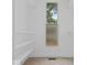 A walk-in closet with white walls, carpeted floor, shelves, clothing rods, and a window at 720 Blanchard St, Shelbyville, IN 46176
