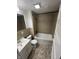 Bathroom featuring a single sink vanity, toilet and bath tub with tan tile surround and tile flooring at 733 Haugh St, Indianapolis, IN 46222