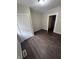 Bedroom featuring dark wood floors, neutral paint, and white trim for a comfortable feel at 733 Haugh St, Indianapolis, IN 46222