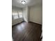 Bedroom showcasing dark wood floors, natural light, and neutral-tone painted walls at 733 Haugh St, Indianapolis, IN 46222