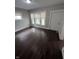 This light-filled bedroom features new flooring, fresh paint, and bright windows with mini blinds at 733 Haugh St, Indianapolis, IN 46222