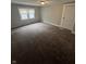 Bedroom featuring neutral walls, base trim, carpeted flooring and window at 733 Haugh St, Indianapolis, IN 46222